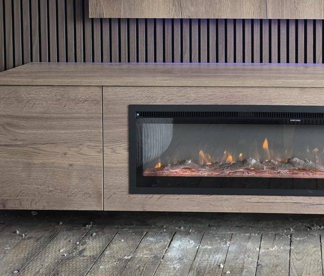 Grain-matched oak media wall cabinet doors around a linear electric fire